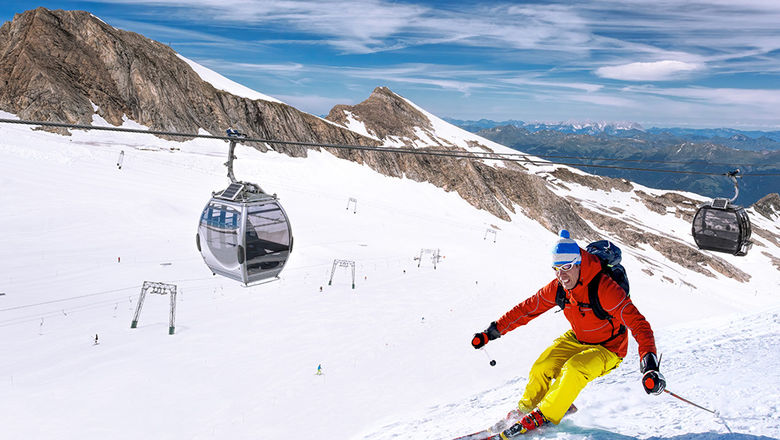 Skiing downhill from high mountains in Zell am See, Austria.
