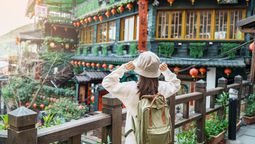 The gift bag includes passes for Taipei's attractions, vouchers for experiences like tea, pineapple sets, accommodations, and wedding photography discounts.