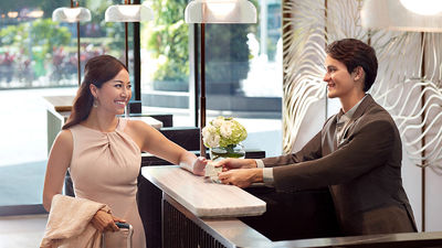 A business guest checking in at Momentus Hotel Alexandra.